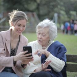 woman showing elderly smartphone