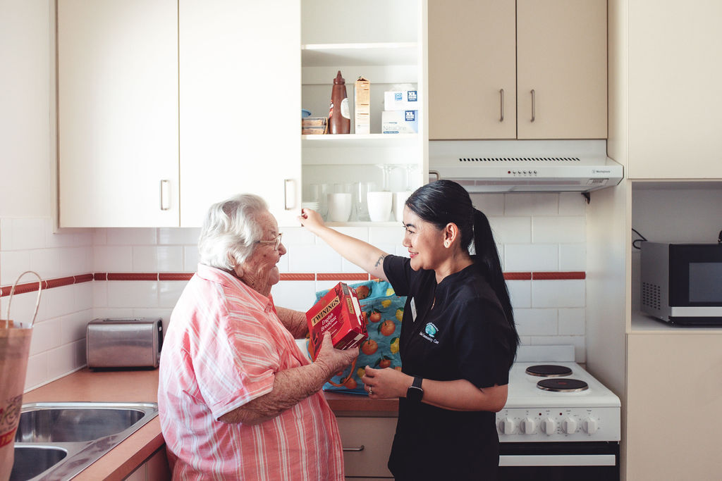 Dale Cottages support worker helping a client in her kitchen at home