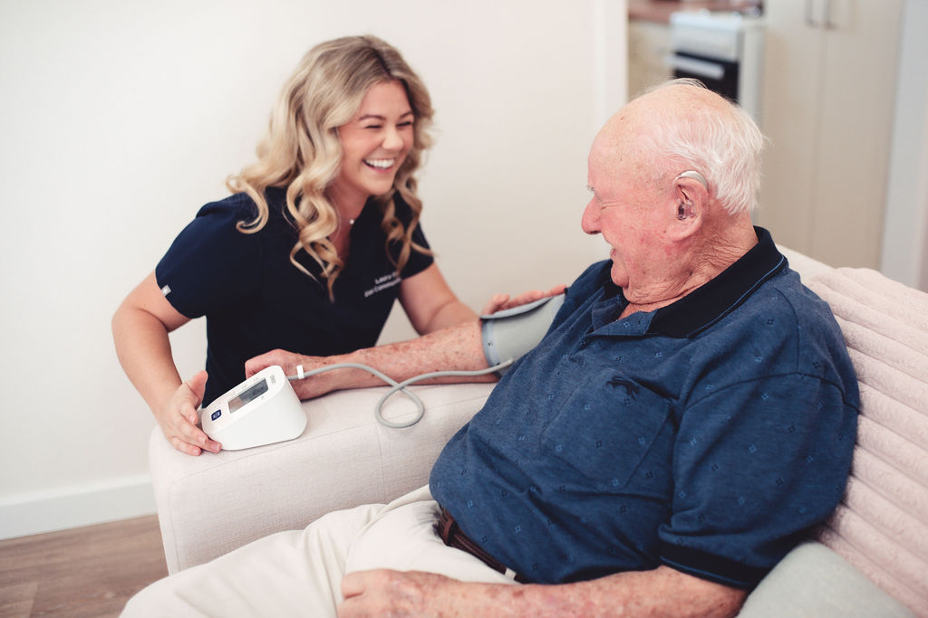 Dale Cottages nurse laughing with a client during a home visit in Armadale